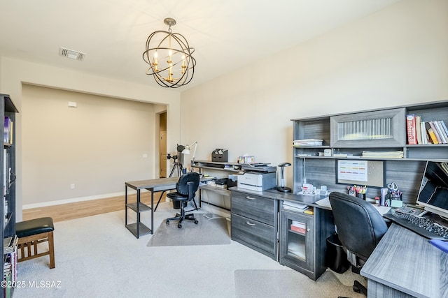 office with wood finished floors, baseboards, visible vents, and a chandelier