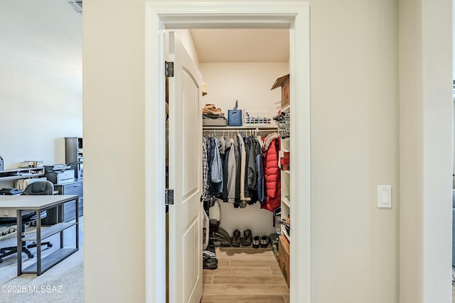 spacious closet featuring visible vents and wood finish floors