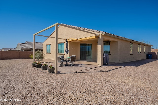 back of house with a patio, fence, and stucco siding