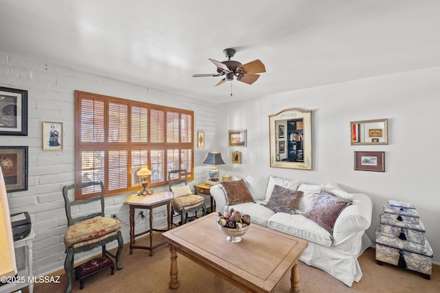 carpeted living room with ceiling fan