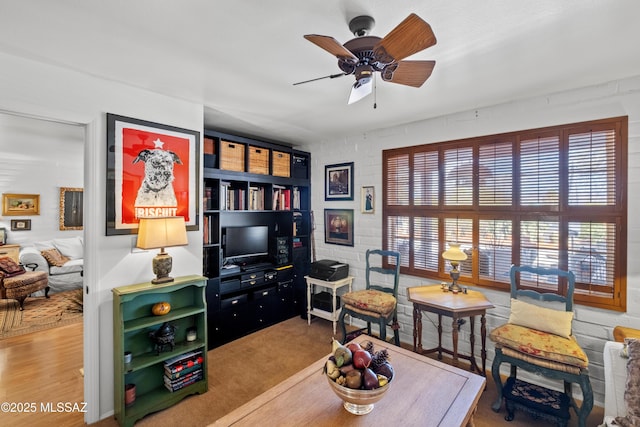 sitting room featuring a ceiling fan