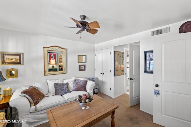 carpeted living room featuring ceiling fan and visible vents