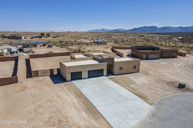 drone / aerial view featuring view of desert and a mountain view