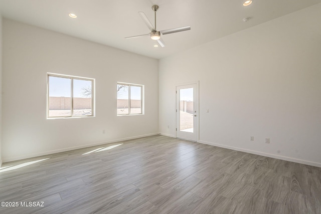 unfurnished room with baseboards, ceiling fan, recessed lighting, and light wood-style floors