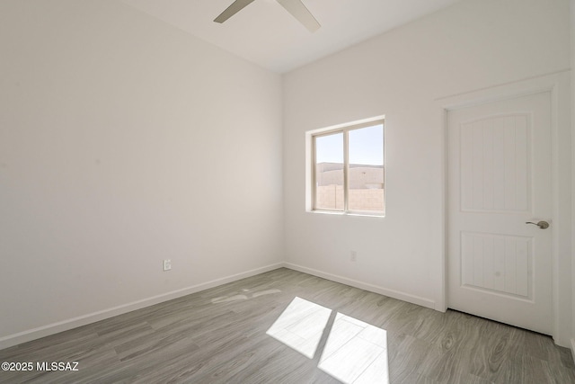 unfurnished room with ceiling fan, baseboards, and wood finished floors