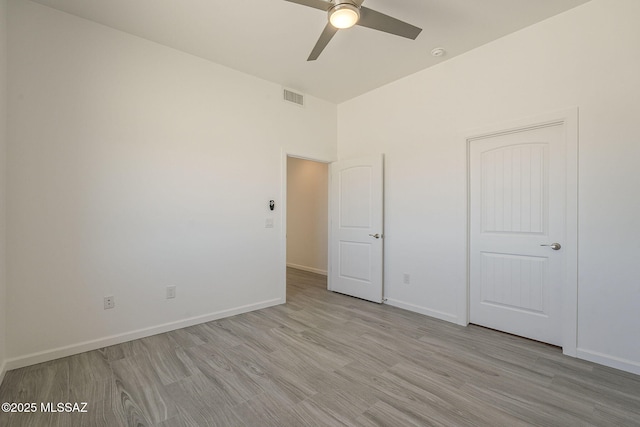 unfurnished bedroom with light wood finished floors, baseboards, visible vents, and a ceiling fan