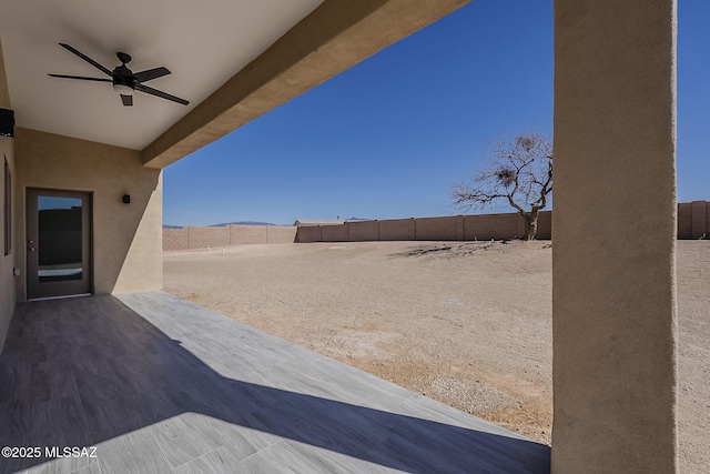 view of yard with a patio, a fenced backyard, and a ceiling fan