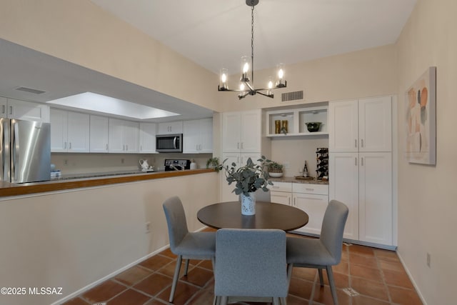 dining space with visible vents, an inviting chandelier, and tile patterned floors