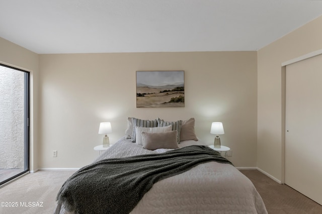 carpeted bedroom featuring baseboards