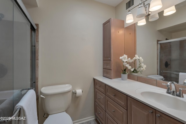 bathroom featuring visible vents, vanity, a tile shower, and toilet