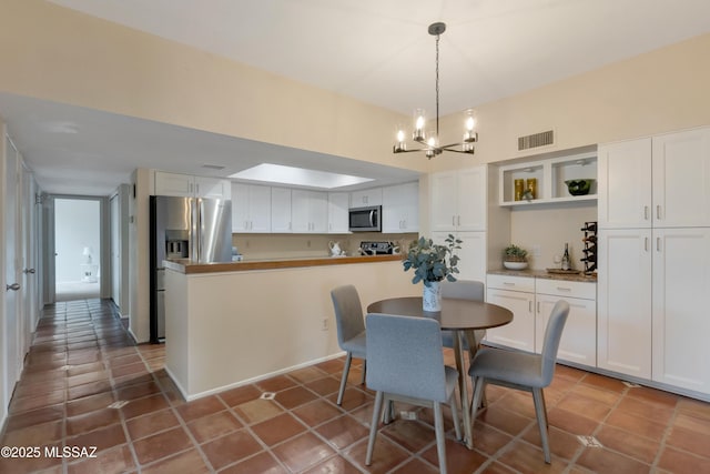 tiled dining area with a chandelier and visible vents