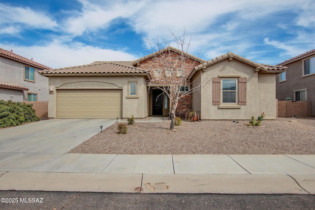 view of front facade featuring a tile roof, stucco siding, concrete driveway, an attached garage, and fence