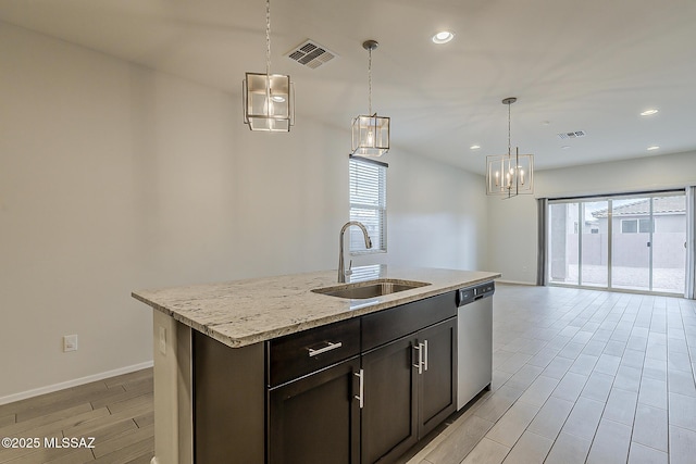 kitchen featuring plenty of natural light, visible vents, a sink, and stainless steel dishwasher