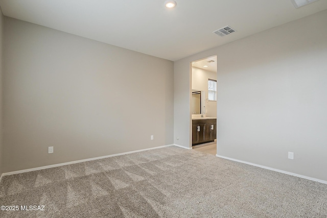 unfurnished room with light carpet, baseboards, visible vents, and recessed lighting