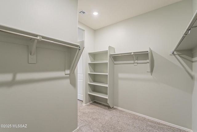 spacious closet with light carpet and visible vents