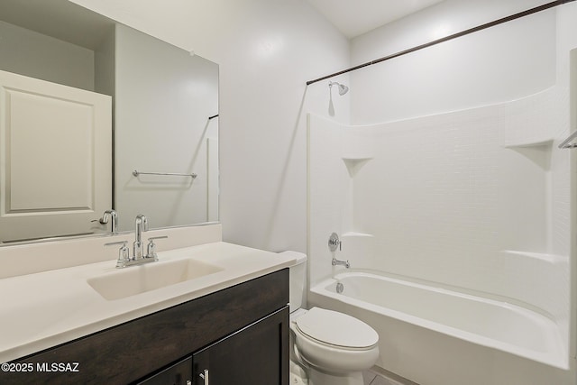 bathroom featuring toilet, bathtub / shower combination, and vanity