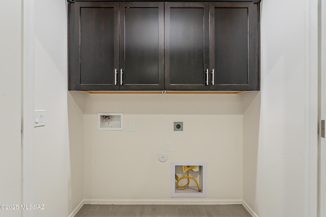 laundry area featuring washer hookup, cabinet space, hookup for an electric dryer, gas dryer hookup, and baseboards