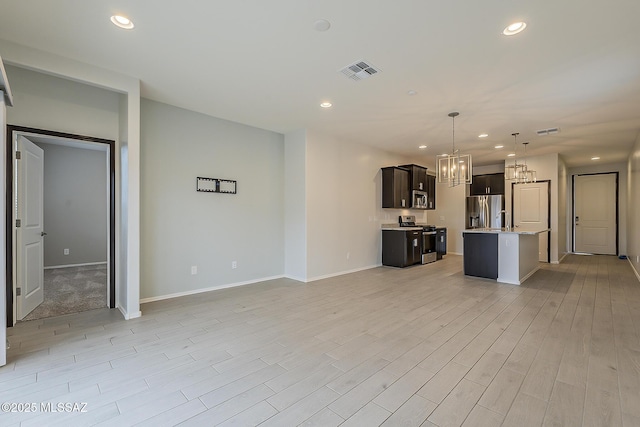 unfurnished living room with a chandelier, recessed lighting, and visible vents