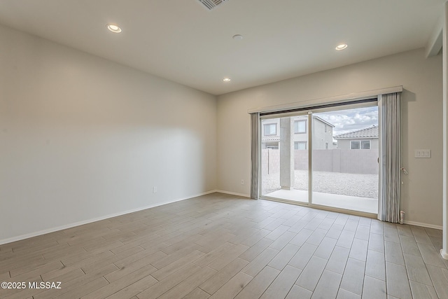 unfurnished room with light wood-style floors, recessed lighting, and baseboards