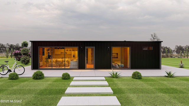 rear view of property featuring a yard and board and batten siding