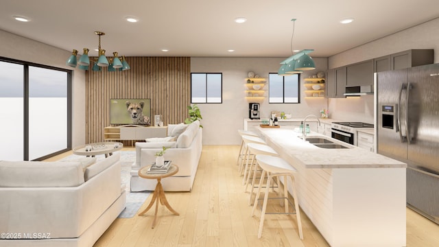 kitchen with white range with electric cooktop, stainless steel fridge with ice dispenser, light countertops, light wood-style floors, and a sink