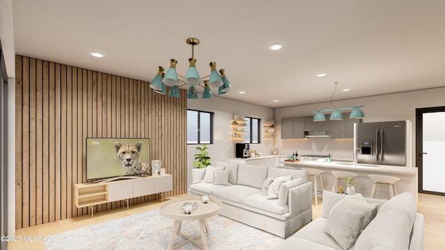 living area featuring a chandelier, recessed lighting, and light wood-type flooring