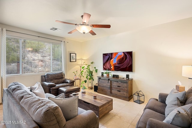 living area featuring light tile patterned floors, ceiling fan, and visible vents