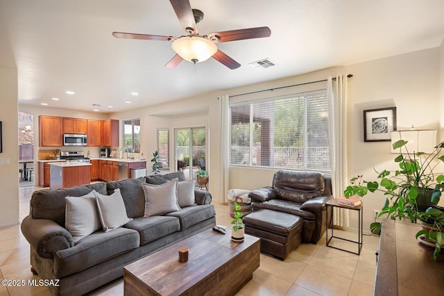 living area featuring a ceiling fan, light tile patterned flooring, visible vents, and recessed lighting