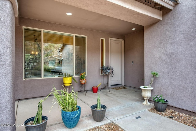 doorway to property with a patio area and stucco siding