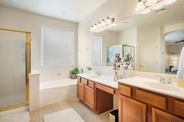 bathroom featuring a stall shower, tile patterned flooring, visible vents, and a sink