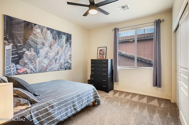 carpeted bedroom featuring a ceiling fan, a closet, visible vents, and baseboards