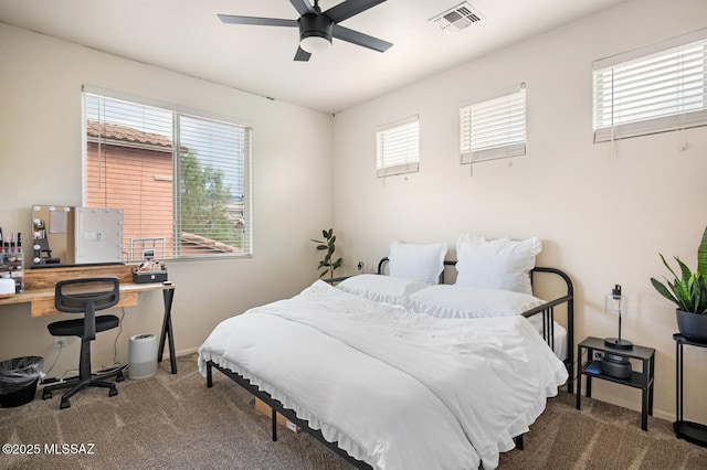 bedroom with multiple windows, visible vents, and carpet flooring