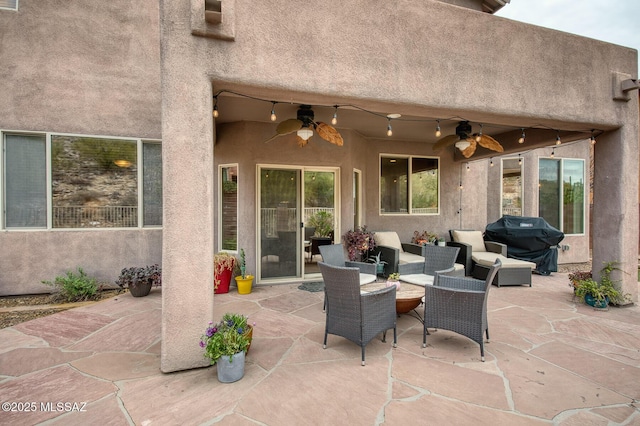 view of patio / terrace with ceiling fan, an outdoor living space, and area for grilling