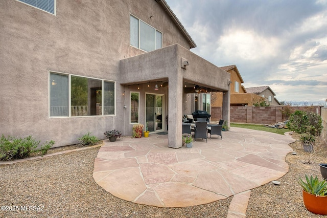 view of patio / terrace featuring fence and a ceiling fan