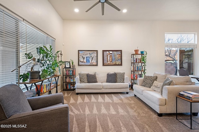 carpeted living area with a ceiling fan and recessed lighting