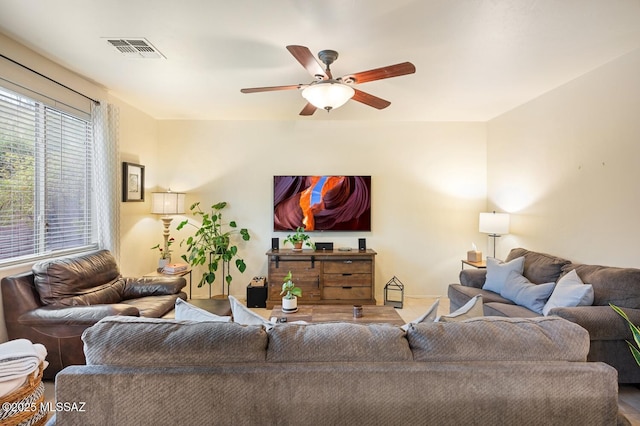 living room featuring visible vents and a ceiling fan