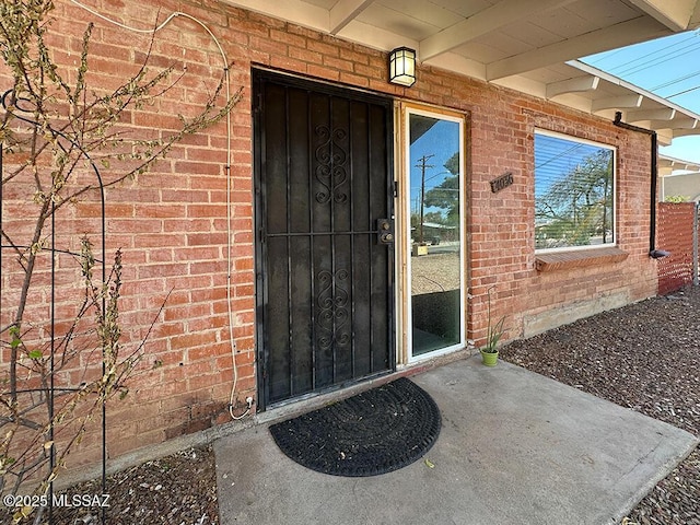 entrance to property with brick siding