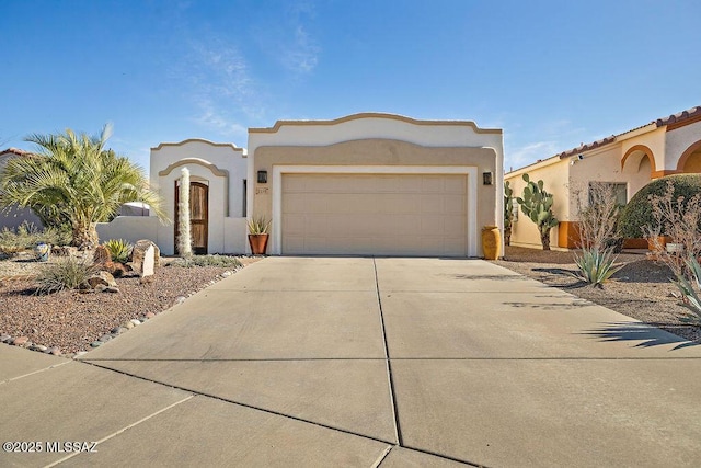 mediterranean / spanish-style house with driveway, an attached garage, and stucco siding