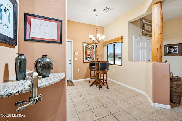 dining area with visible vents, a notable chandelier, baseboards, and light tile patterned floors