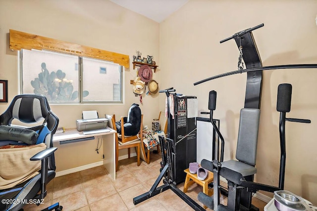 workout room with light tile patterned flooring and baseboards