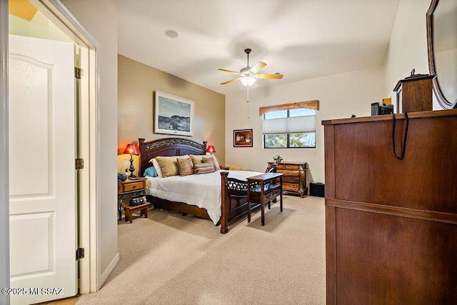 bedroom with light carpet and a ceiling fan