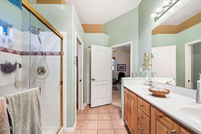 full bathroom with a shower stall, double vanity, a sink, and tile patterned floors