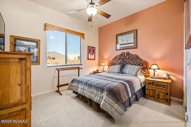 bedroom featuring a ceiling fan, light colored carpet, and baseboards