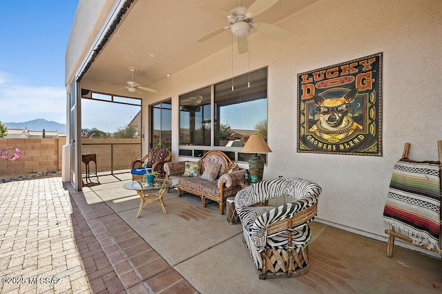 view of patio / terrace featuring ceiling fan, fence, and an outdoor hangout area