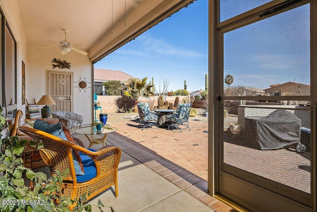 view of patio / terrace with outdoor dining space, ceiling fan, and fence