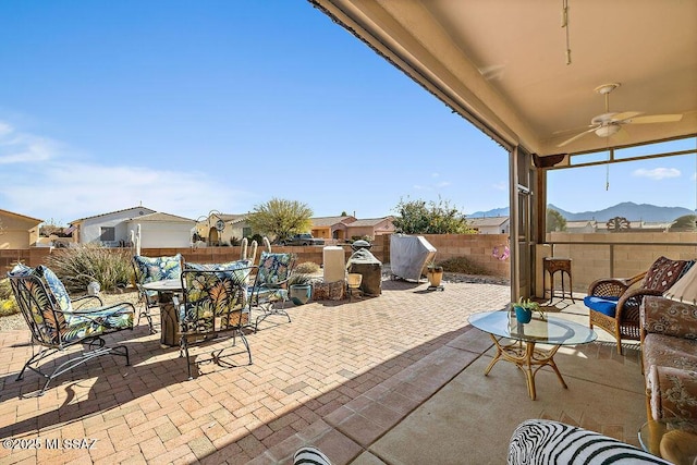 view of patio / terrace featuring ceiling fan, outdoor dining area, and a fenced backyard