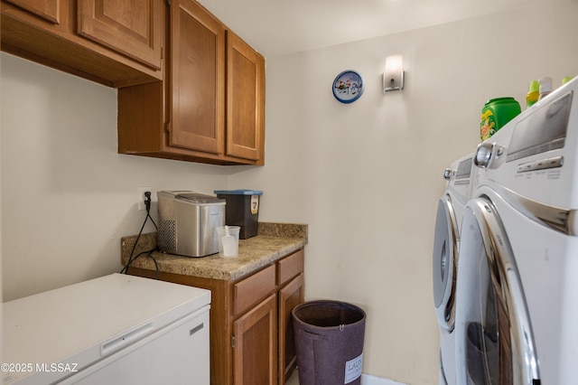 washroom featuring cabinet space and washing machine and clothes dryer