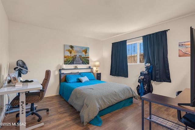 bedroom featuring wood finished floors and baseboards