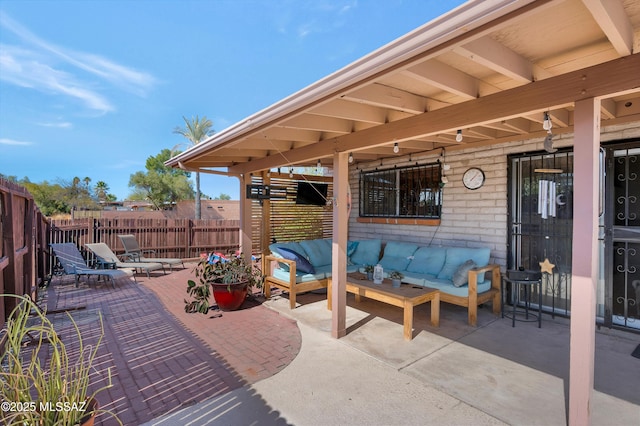 view of patio with fence and outdoor lounge area