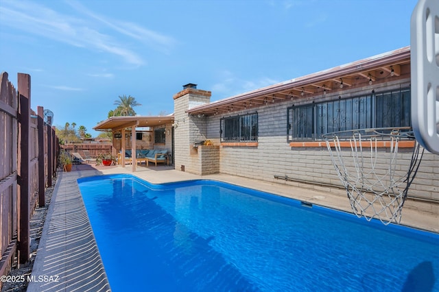 view of pool featuring a patio area and a fenced backyard